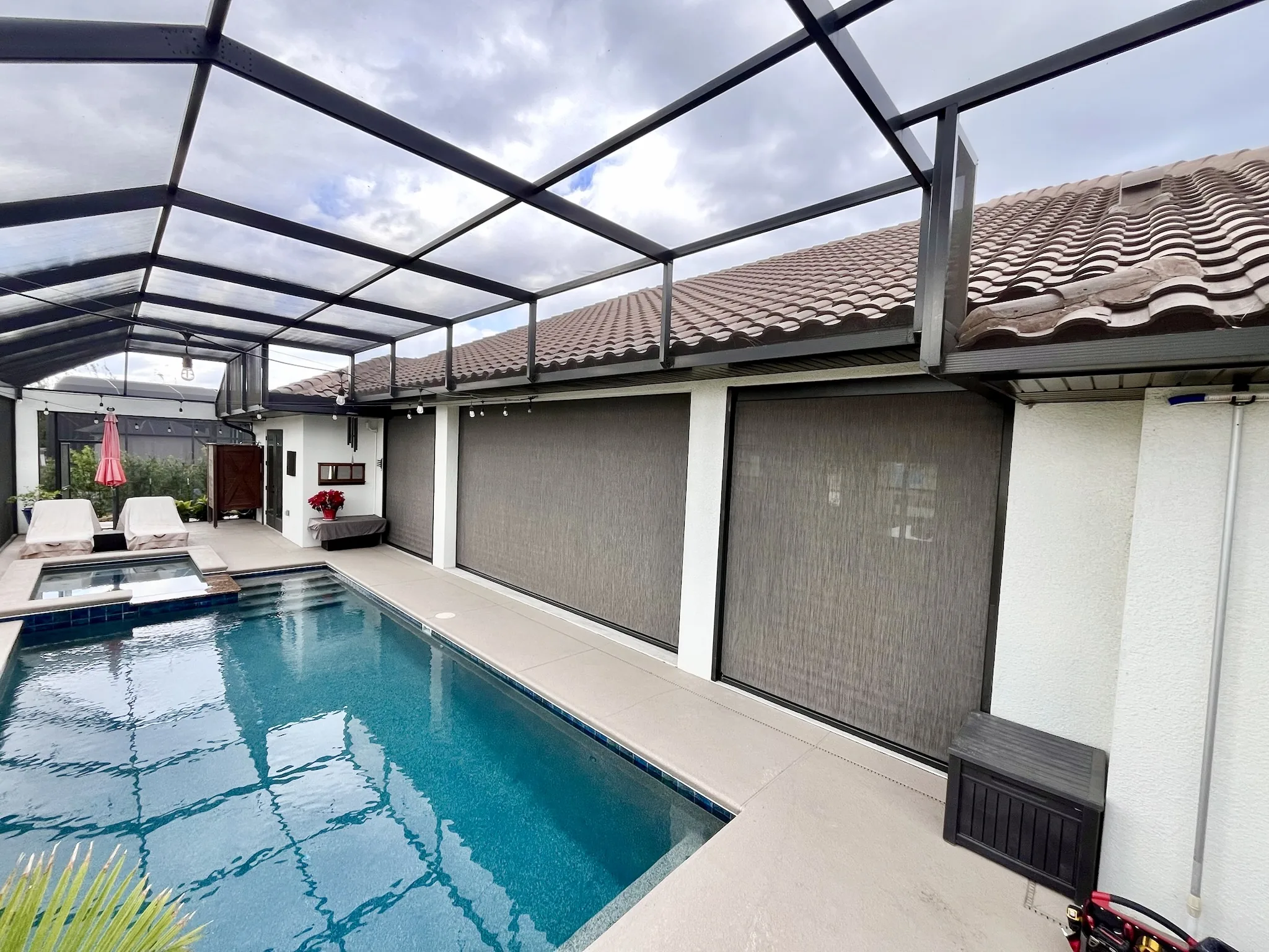 Motorized exterior shades enclosing a Florida pool lanai